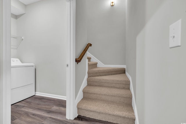 stairs featuring wood finished floors, washer / dryer, and baseboards