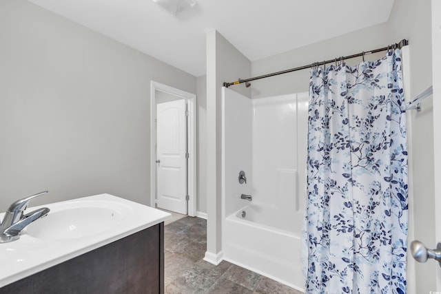 full bathroom with shower / bath combination with curtain, baseboards, and a sink