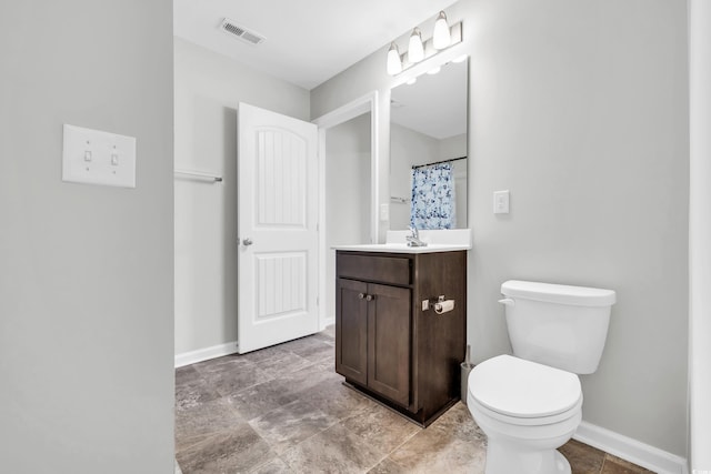 bathroom with toilet, baseboards, visible vents, and vanity