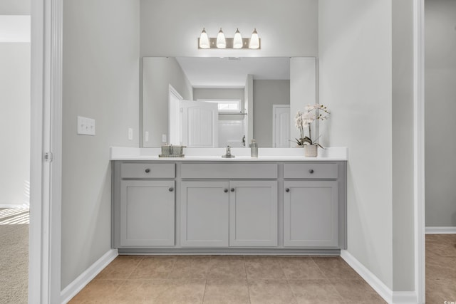 full bathroom with vanity, baseboards, and tile patterned floors