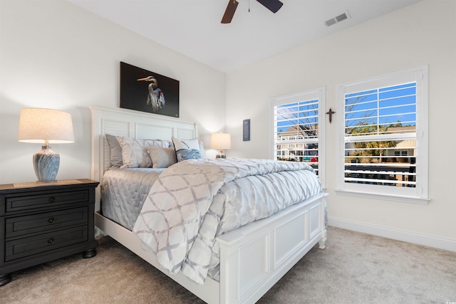 bedroom featuring light colored carpet and ceiling fan