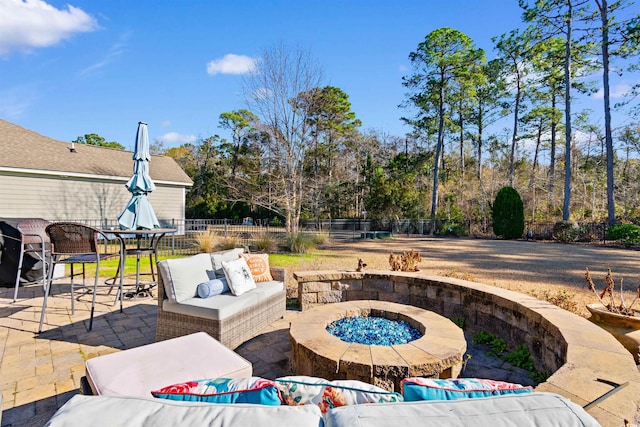 view of patio featuring an outdoor living space with a fire pit