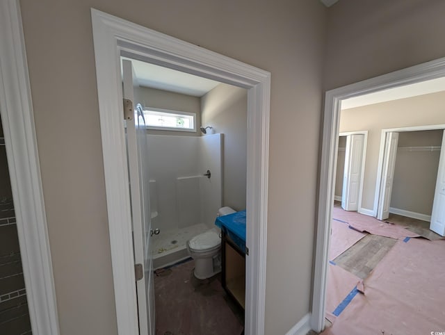 bathroom with a shower and toilet