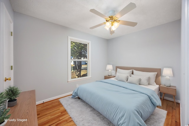 bedroom featuring ceiling fan and hardwood / wood-style floors