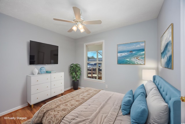 bedroom with ceiling fan and hardwood / wood-style floors