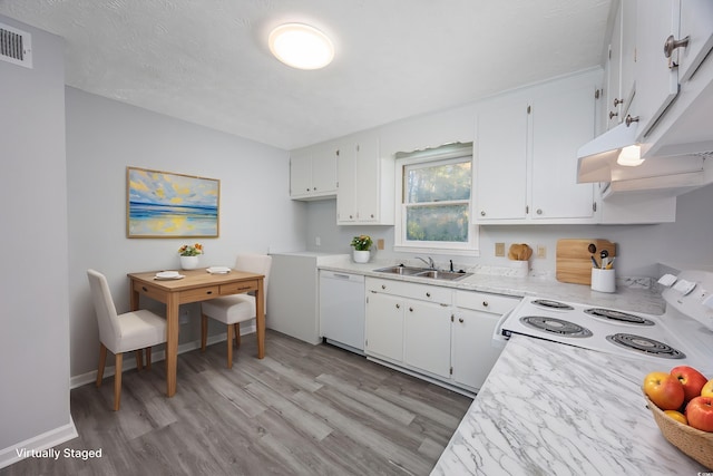 kitchen with sink, white cabinets, white appliances, and light hardwood / wood-style flooring