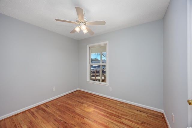 empty room featuring a textured ceiling, light hardwood / wood-style floors, and ceiling fan