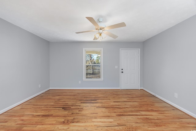 empty room with ceiling fan and light hardwood / wood-style floors