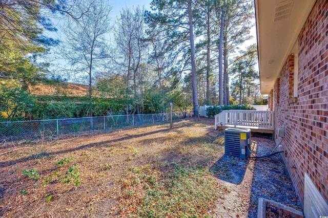 view of yard featuring a deck and cooling unit