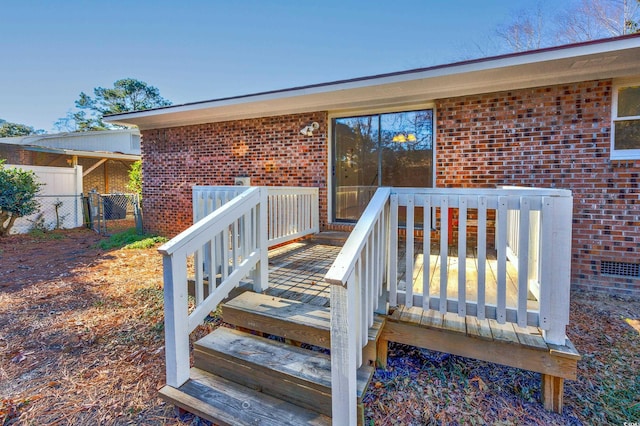 view of exterior entry featuring a deck