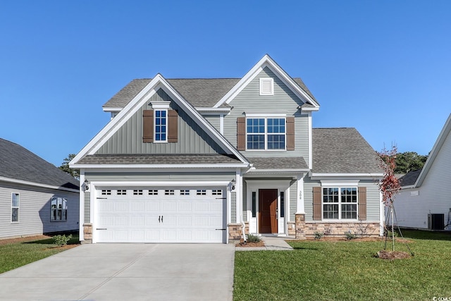 craftsman-style home featuring a garage, central AC, and a front lawn