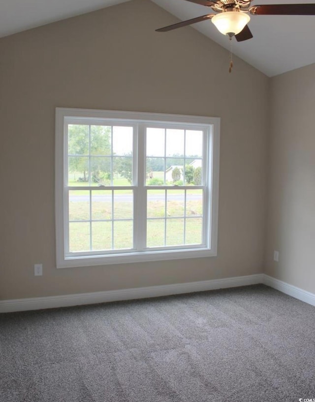 carpeted empty room featuring ceiling fan, a healthy amount of sunlight, and lofted ceiling