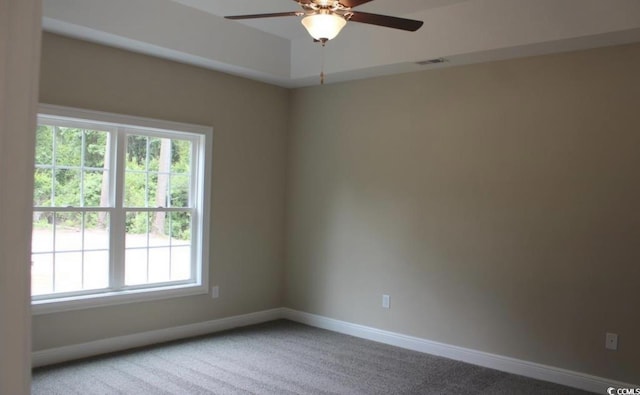 carpeted empty room featuring a wealth of natural light and ceiling fan