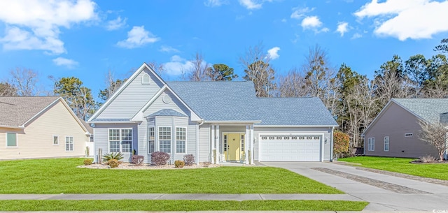 view of front of property featuring a front lawn and a garage