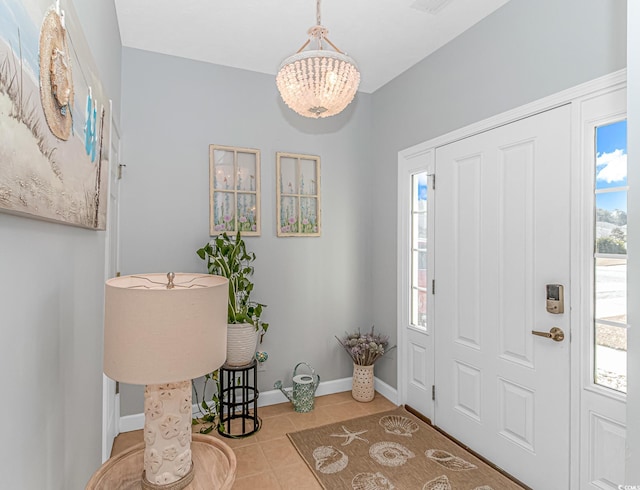 entrance foyer featuring an inviting chandelier and light tile patterned floors