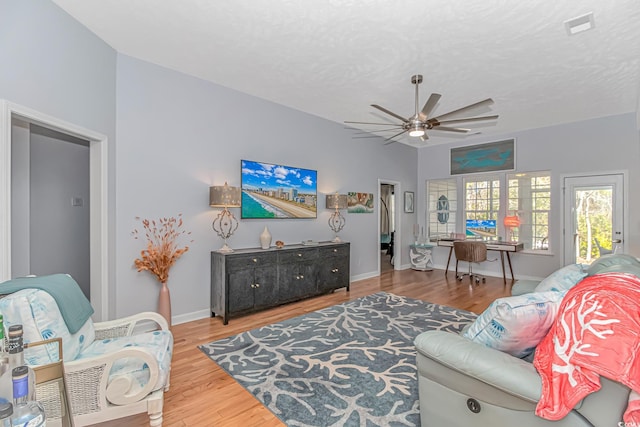 living room with ceiling fan and hardwood / wood-style floors