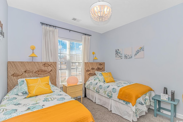 bedroom with a notable chandelier and carpet floors