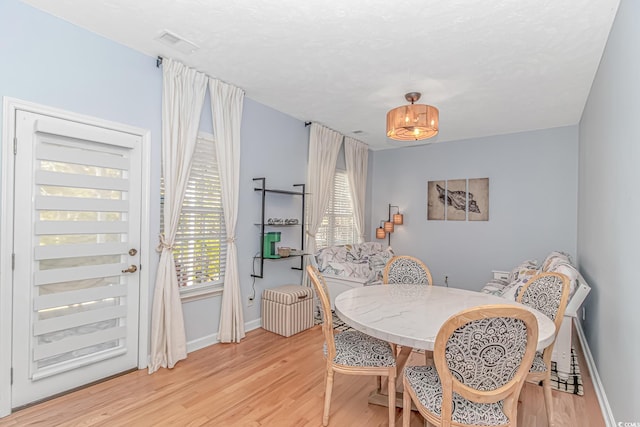 dining area featuring light hardwood / wood-style floors and a wealth of natural light