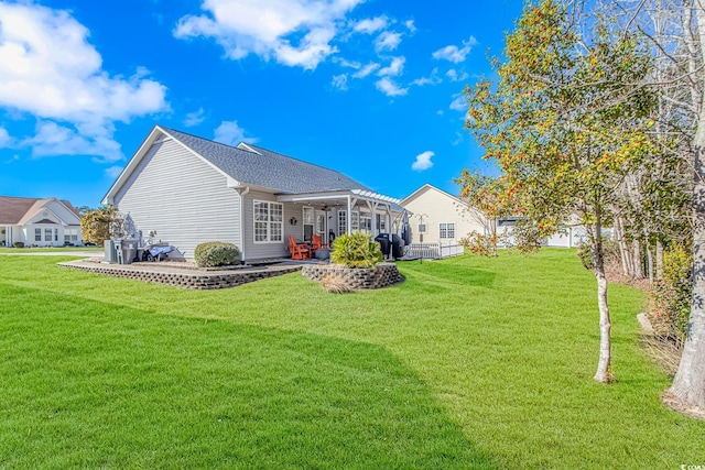 back of house featuring a patio area and a lawn