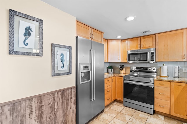 kitchen featuring light tile patterned floors, backsplash, light stone countertops, and appliances with stainless steel finishes