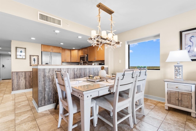 dining space with an inviting chandelier and light tile patterned floors