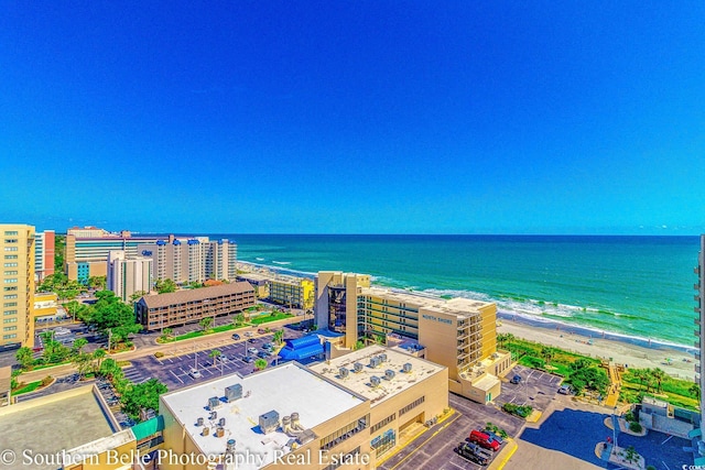 drone / aerial view with a water view and a beach view