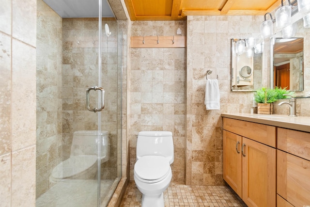 bathroom with tile walls, vanity, walk in shower, toilet, and tile patterned floors