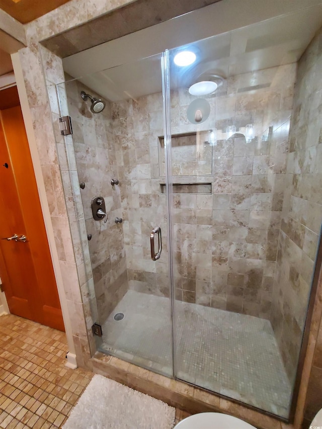 bathroom featuring walk in shower and tile patterned flooring