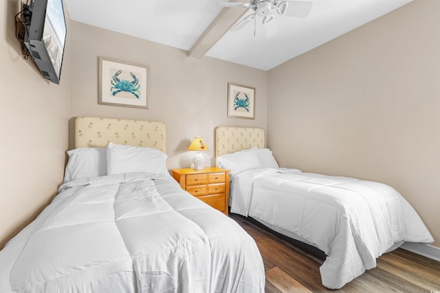 bedroom with dark hardwood / wood-style flooring, ceiling fan, and beamed ceiling