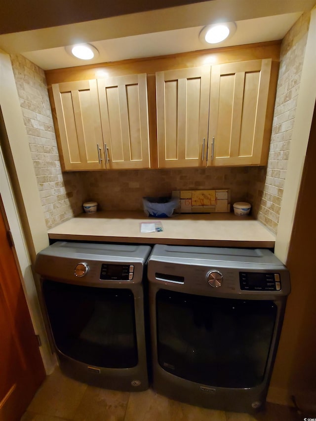 washroom featuring cabinets and separate washer and dryer