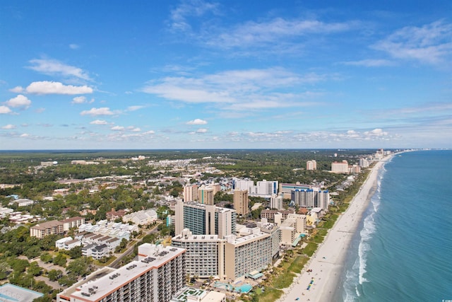 drone / aerial view featuring a beach view and a water view