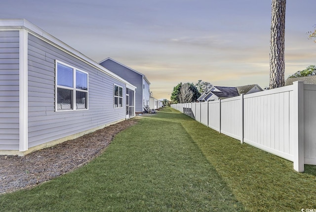 view of yard at dusk