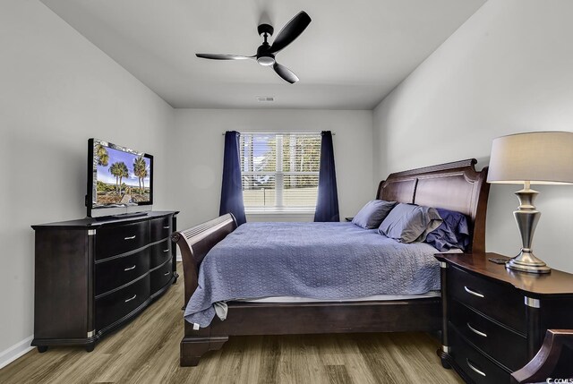 bedroom with ceiling fan and light wood-type flooring