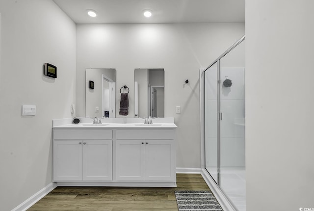 bathroom with vanity, wood-type flooring, and walk in shower