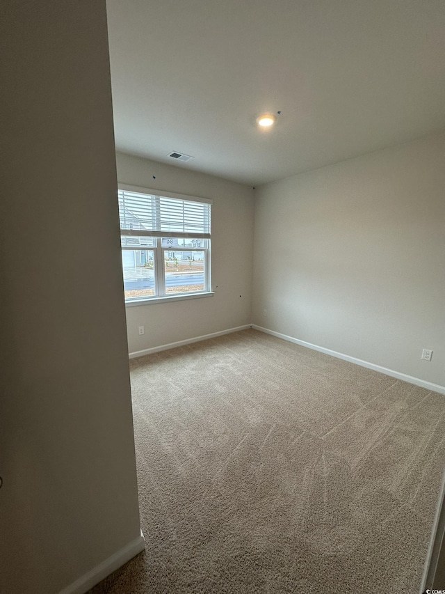 spare room featuring carpet floors