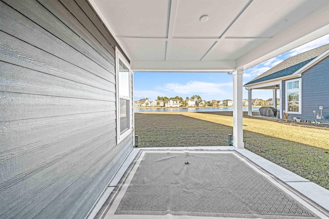 unfurnished sunroom with a water view