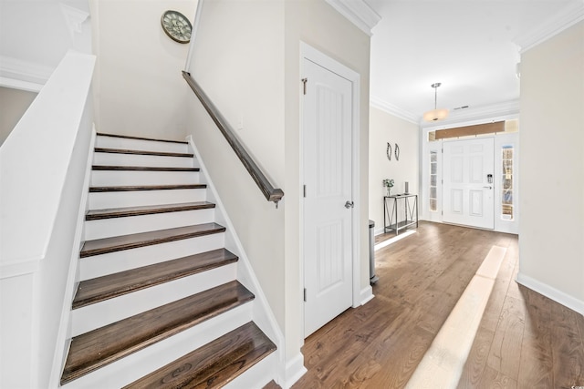 foyer featuring dark hardwood / wood-style flooring and crown molding