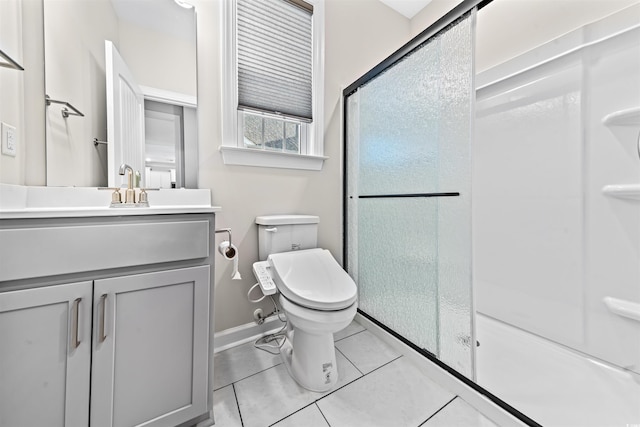 bathroom with tile patterned floors, toilet, vanity, and walk in shower