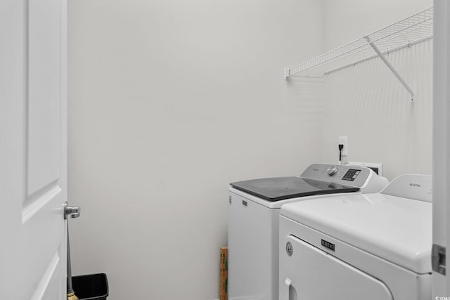 washroom featuring washer and clothes dryer