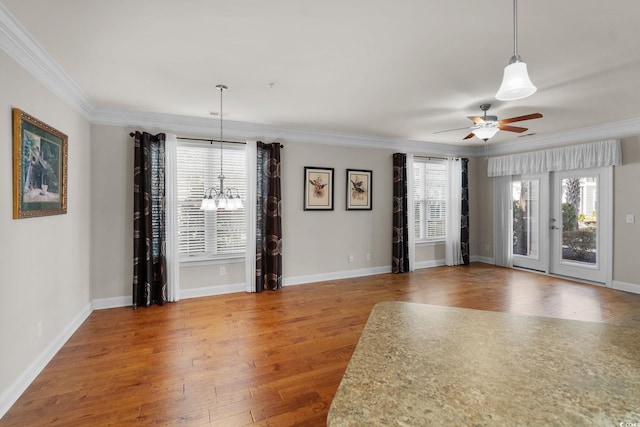 interior space featuring hardwood / wood-style floors, crown molding, and ceiling fan with notable chandelier