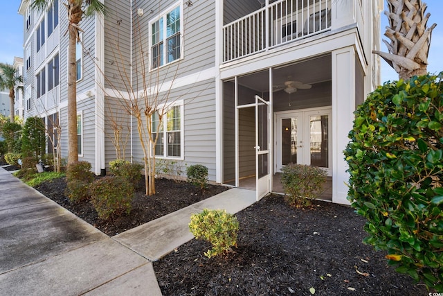 doorway to property featuring french doors, ceiling fan, and a balcony