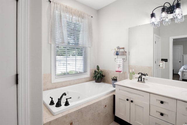 bathroom with vanity and tiled bath