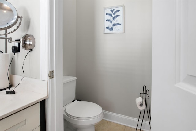 bathroom with tile patterned floors, vanity, and toilet