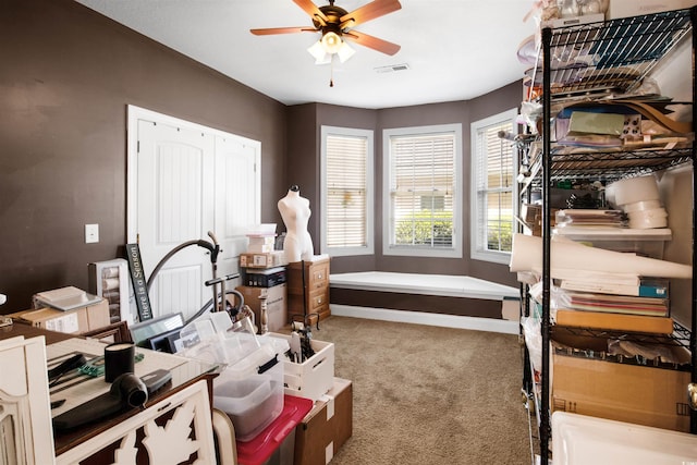 interior space with ceiling fan