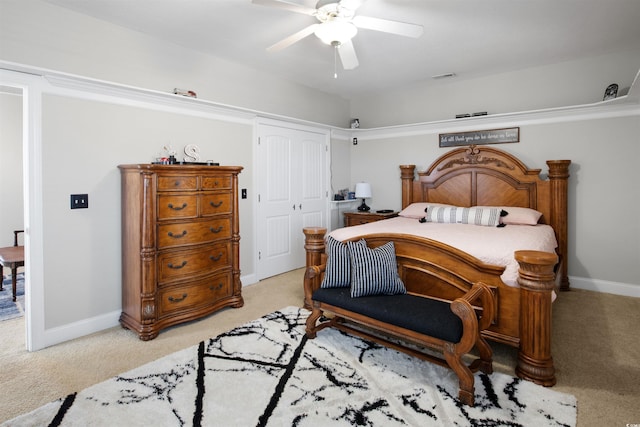 bedroom with ceiling fan, a closet, and light carpet