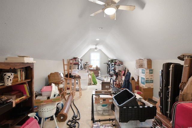 interior space with ceiling fan, lofted ceiling, and carpet floors