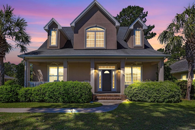 view of front of house with a porch and a yard