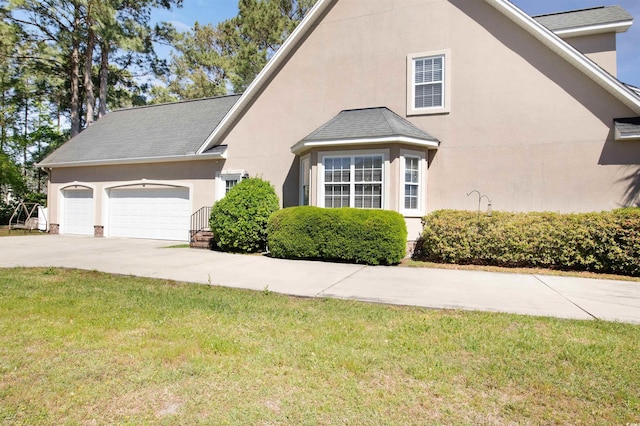 view of front of house with a front yard and a garage