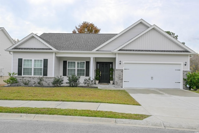 view of front of property with a front yard and a garage