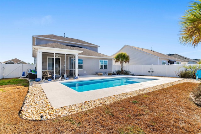 view of pool with a sunroom and a patio area